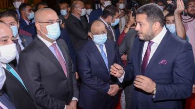 وزيرا الإسكان والتنمية المحلية يتفقدان جناح شركة " آكام " للتطوير العقارى خلال معرض أخبار اليوم